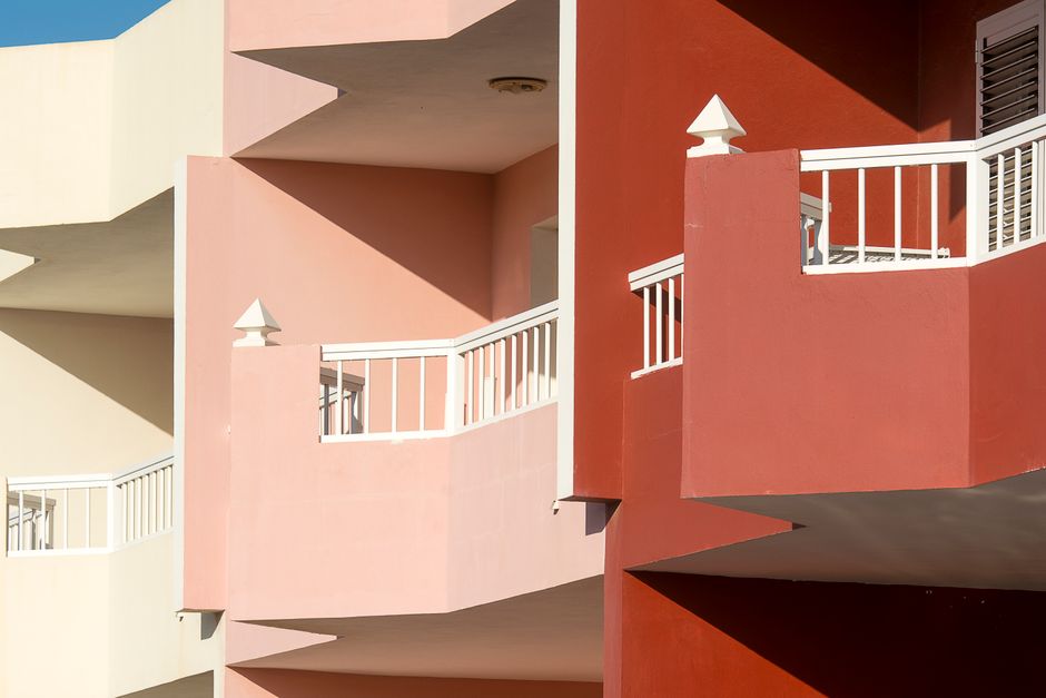 A painted building exterior with balconies.