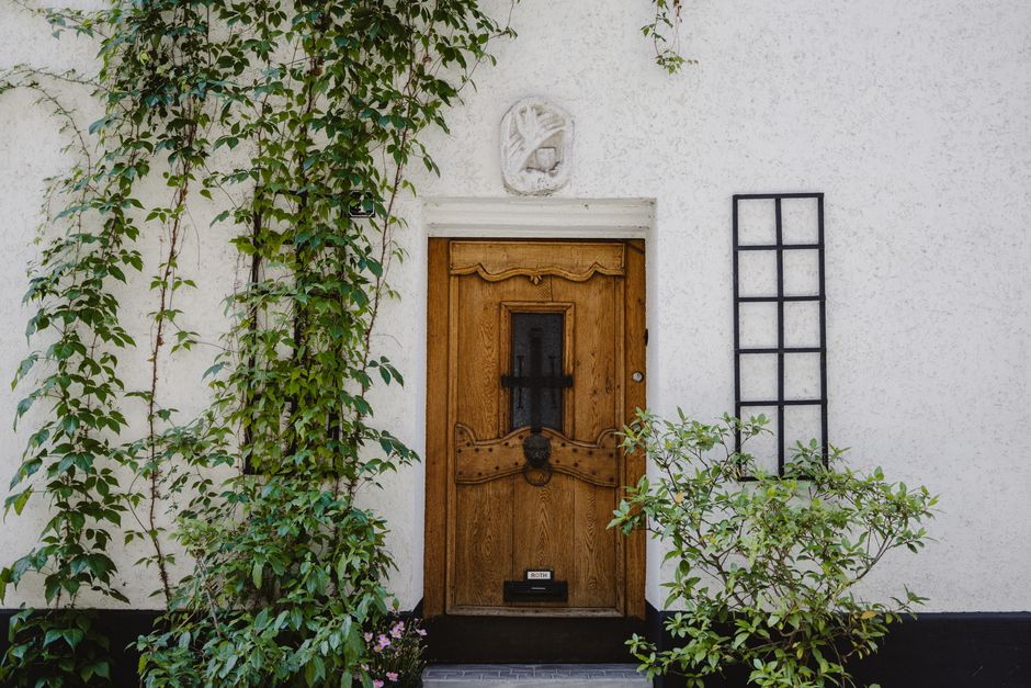 A painted wooden door on a house facade.